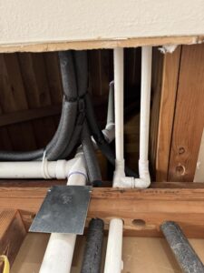 Licensed Texas plumber installing code-compliant P-trap under bathroom sink in Houston home