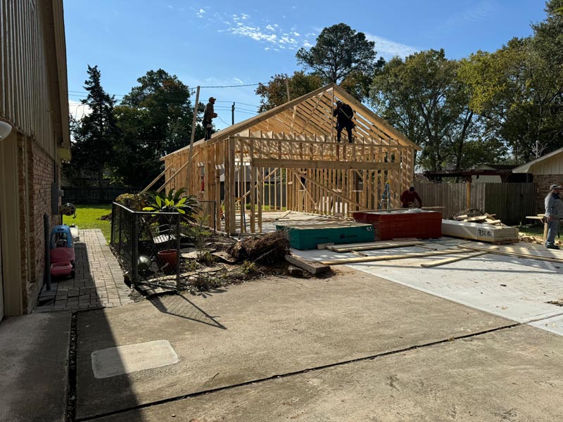 Active construction site showing roof framing work on Houston detached garage project