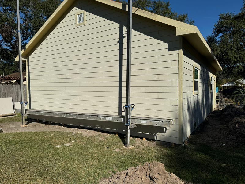 Exterior view of garage with horizontal siding during final construction phase in Houston