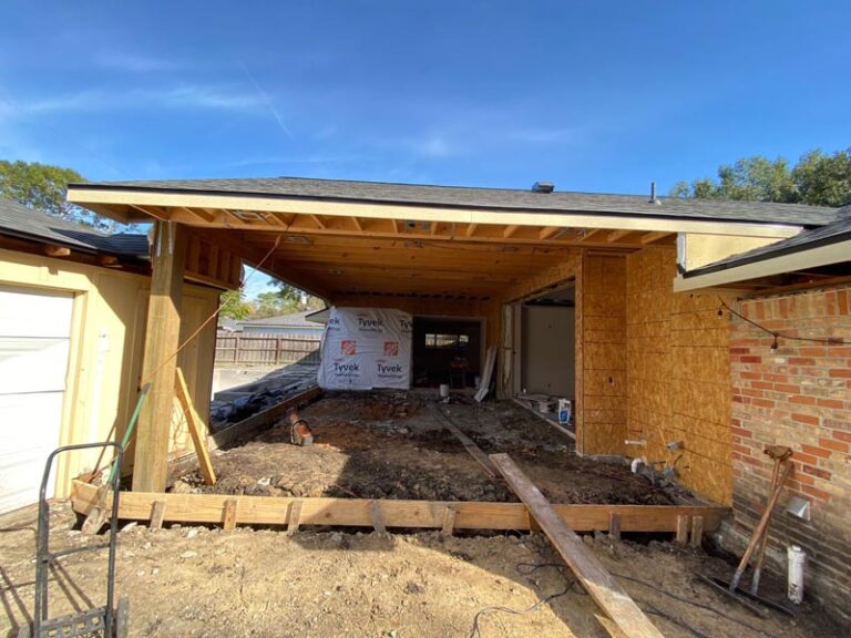 New addition framing under a finished roofline with formwork for the extended slab in the backyard - in-law suite addition in Houston, TX