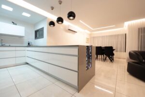 Modern white kitchen with pale blue backsplash in Angleton