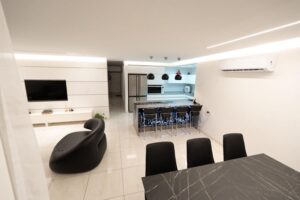 Side view of modern living room, kitchen, and dining area in Houston renovation