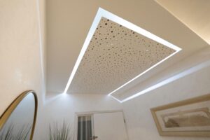 Geometric ceiling design with acoustic panel and LED border lighting in Houston renovation