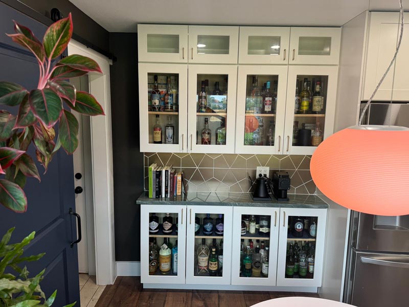 Custom glass-front cabinet display in affordable Houston kitchen remodel