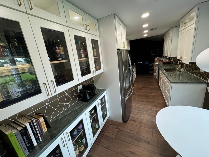 Glass-front display cabinets and beverage storage in affordable Houston kitchen remodeling project