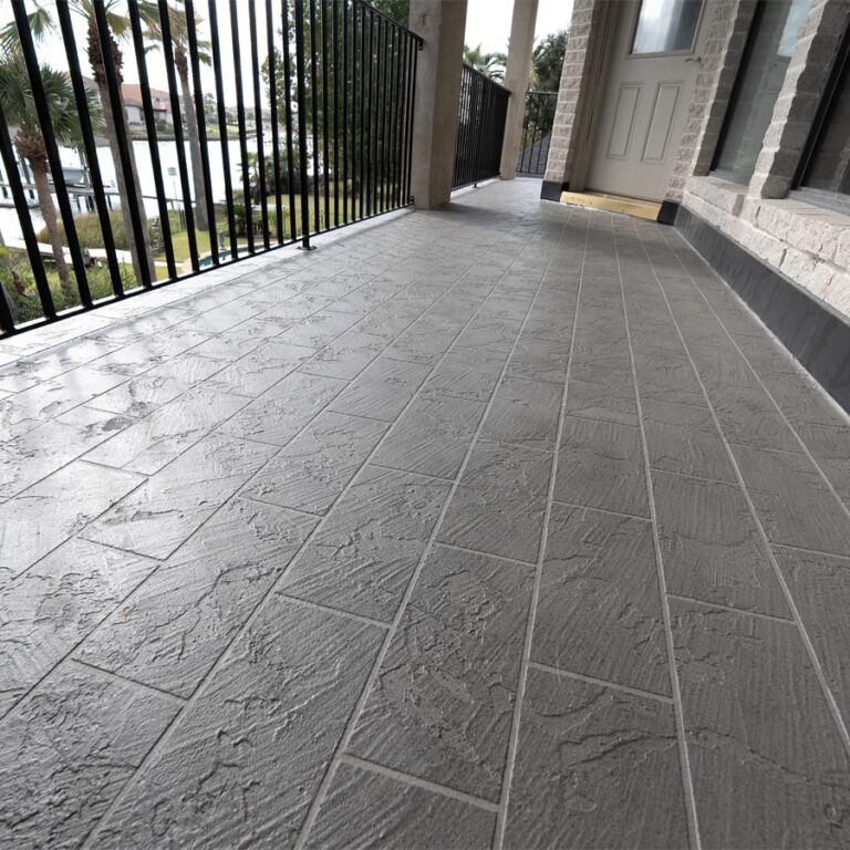 Finished balcony with slate-look stamped waterproof coating and black iron railing at the entry door, 77586 site