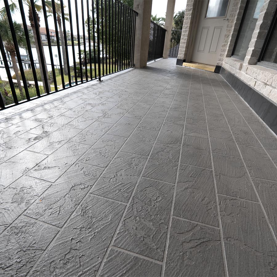 Completed balcony waterproofing with decorative stamped concrete finish