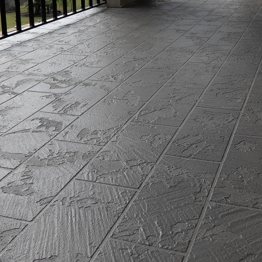 Wide view of stamped slate-pattern waterproof coating on a covered balcony in Seabrook, TX