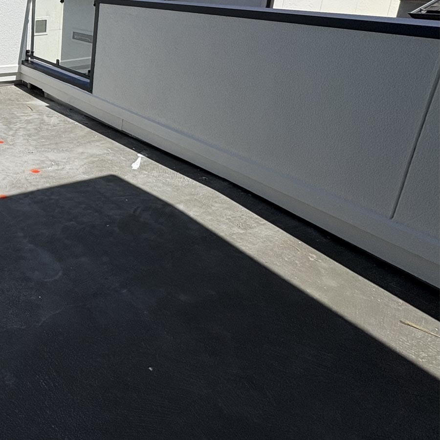 Balcony decking with compromised drainage layer requiring replacement in 77007