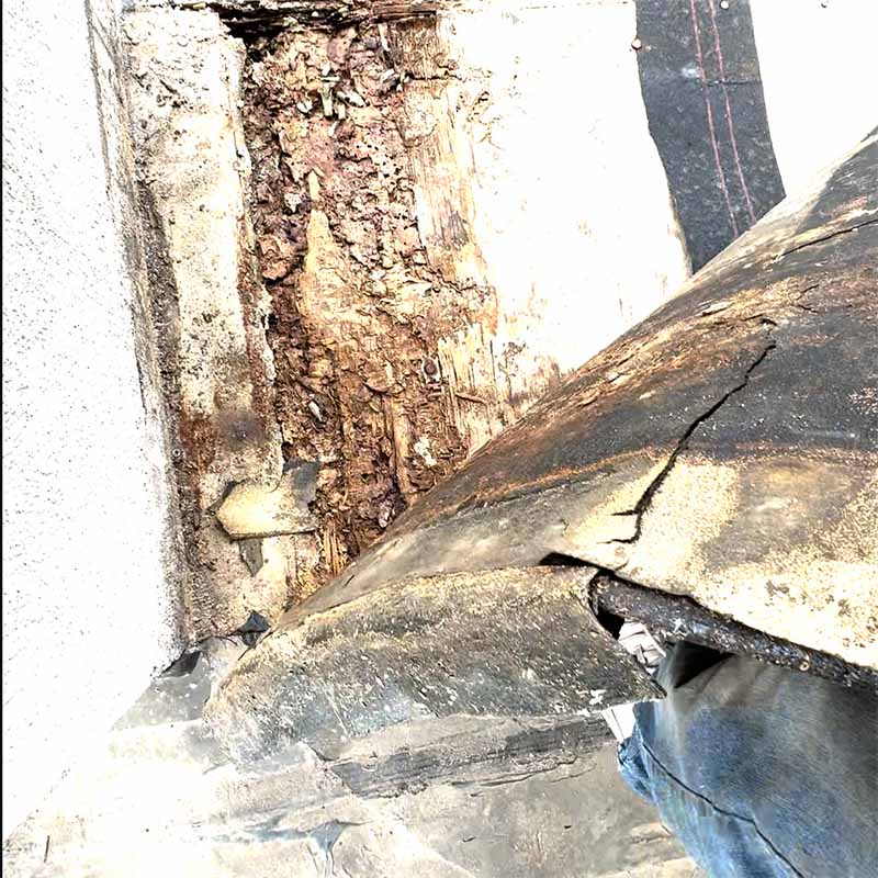 Severely rotted framing exposed beside a balcony column after membrane removal in Seabrook, TX