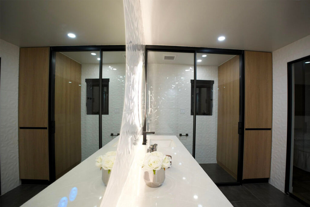HOA-compliant quartz countertop installation in condo bathroom with glass partition walls